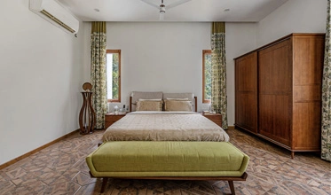 Pine Suite bedroom with elegant interiors at Punya Farms.