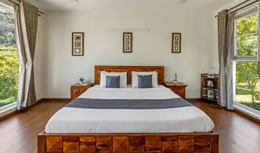 Spacious master bedroom at Kalpavriksha Villa in Kotagiri with premium interiors.